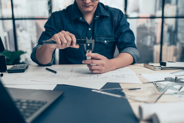 Architecture hands hold vernier caliper working and checking joint pipe scale with bathroom...