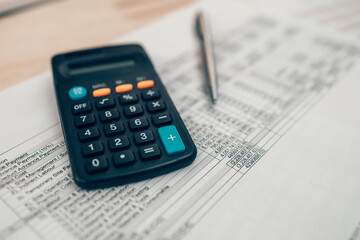 Pen and calculator on desk office. Object for calculator to calculate balance, projit, currency and cost. Accounting and  Financial concept.