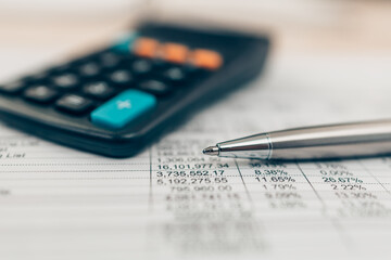 Pen and calculator on desk office. Object for calculator to calculate balance, projit, currency and cost. Accounting and  Financial concept.