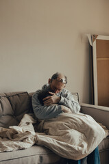 Fototapeta premium Ukrainian excited gray-haired man protects his little frightened granddaughter. Stop the war. Pray for Ukraine. We support Ukraine.