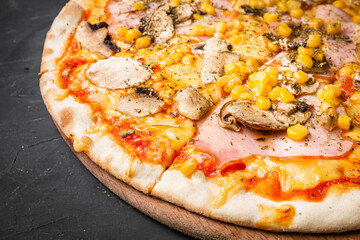 hot delicious traditional italian pizza on a dark stone background