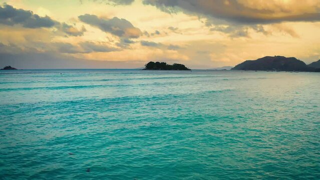 Flying above the coast of Praslin Island in Seychelles at sunset