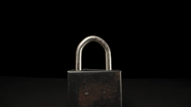 Black metal lock, camera span through. Dolly slider extreme close-up. Laowa Probe