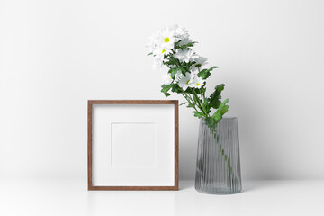 Square frame mockup in white minimalistic interior with fresh flowers in vase