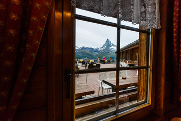 beautiful view of restaurant surround by mist lake and mountains with empty table