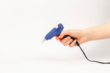 woman holding glue gun on white background