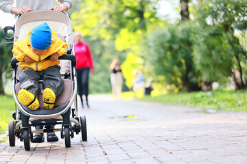 autumn walk child in a stroller, street outdoor city landscape