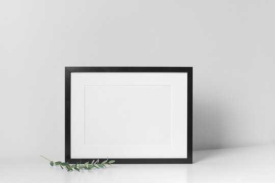 Landscape frame mockup in white minimalistic room with copy space for artwork, photo or print presentation