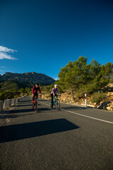 Cyclists in the hills in and around Calpe village with Bernia mountain in the background, area very popular with cyclists, Costa Blanca, Alicante, Spain