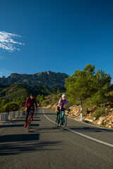 Cyclists in the hills in and around Calpe village with Bernia mountain in the background, area very popular with cyclists, Costa Blanca, Alicante, Spain