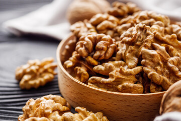 dried walnuts on a black rustic wooden background