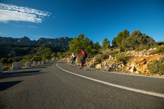 Cyclists in the hills in and around Calpe village with Bernia mountain in the background, area very popular with cyclists, Costa Blanca, Alicante, Spain