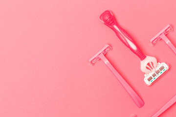 Female Hygiene Concepts. Variety of Female Pink Disposable Razors Shavers Placed Bulk Over Trendy Pink Coral Background