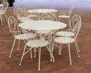 White metallic tables and chairs in summer cafe