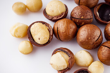 fresh macadamia nuts on a white acrylic background