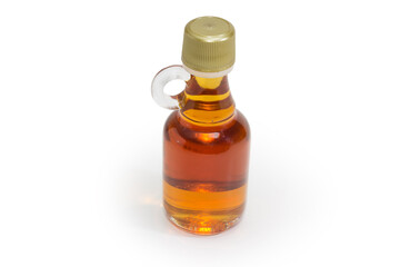Bottled maple syrup on a white background