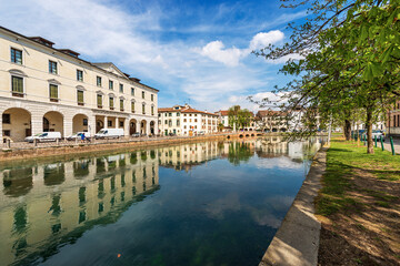 Fototapeta na wymiar Cityscape of Treviso downtown with the river Sile with the street called Riviera Garibaldi and the small bridge called Ponte Dante. Veneto, Italy, Europe.
