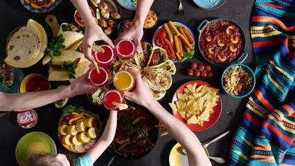 A happy group of friends celebrate together the Cinco de Mayo holiday in Mexico. National Mexican food on the table, mexican cuisine