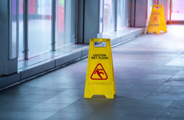Yellow Caution wet floor sign on wet floor