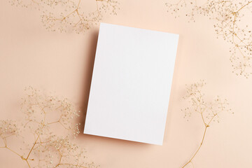 Invitation or greeting card mockup with dry gypsophila flowers