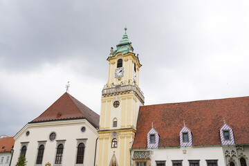 Fototapeta na wymiar street with houses and church in Slovakia, rainy weather