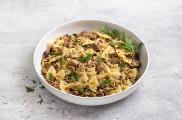 Traditional Jewish dish kasha varnishkes: buckwheat, pasta, champignon mushrooms, fried onions with...