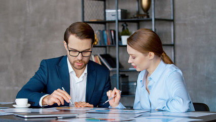 Two business people talk project strategy at meeting room