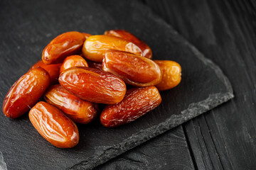juicy royal dates on a black wooden rustic background
