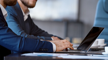 Young businessman person using a computer laptop notebook in technology device in office
