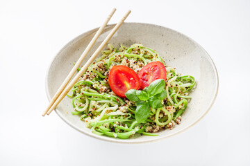 zucchini noodles with quinoa on a white background