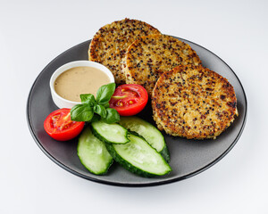 Quinoa cutlet with vegetables on a white background