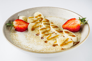 sweet porridge with quinoa and banana on a white background
