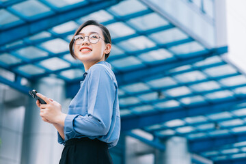 Image of young Asian businesswoman outside - Powered by Adobe