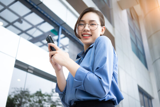 Image of young Asian businesswoman outside