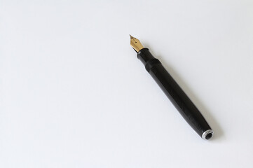 Old ink pen. Ink pen on a light sheet of paper.