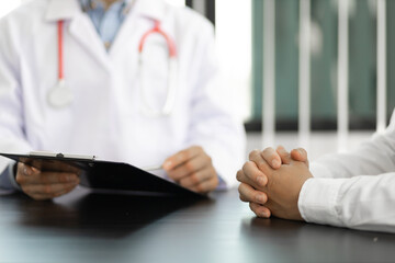 The doctor is conversation to the patient about the illness in the doctor's office and giving advice on health care. Concept of health problem consultation.