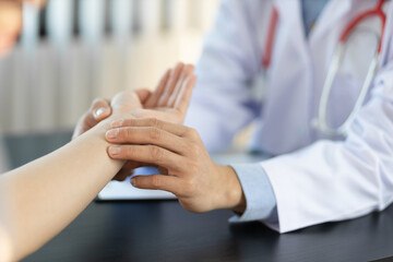 Health and medical examination concept. Doctor checking measuring pressure on patient's hand pulse...