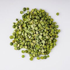 dried green peas on a white acrylic background