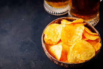 mug of beer and a set of dry fish snacks on a dark background