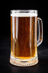 mug of beer and a set of dry fish snacks on a dark background