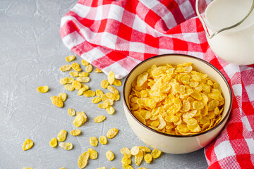 crispy golden cornflakes on a gray concrete background