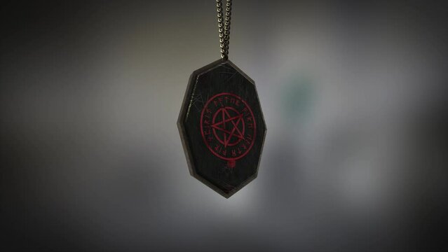 High quality close up render of an unusual metal and stone Pagan pentacle amulet with runes, swinging slowly on the end of a neck chain, with super shallow depth of field abd bokeh background