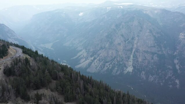 Aerial, car on road trip driving on Beartooth Highway in Montana and Wyoming