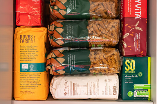 London, UK: April 8, 2022: Cupboard Shelves Full Of Food Provision, Such As Pasta, Rice, Porridge, Canned Tuna, Beans And More. Panic Buying To Survive Pandemic Or Food Crisis