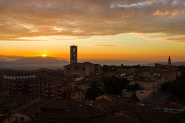 Beautiful dawn sky with morning haze over the old city of Perugia, with medieval bell towers and Umbria countryside in the background