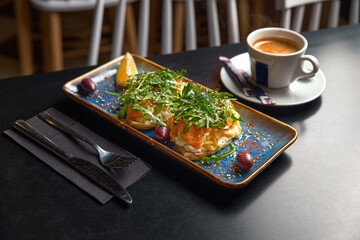 delicious pita bread sandwich with green arugula salad and smoked salmon, yummy healthy food for lunch break at cafe or restaurant or cafeteria