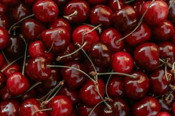 Background image of lying red ripe sweet cherries. Top view. Flat lay. Copy space