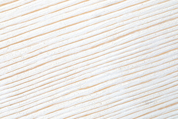 Diagonal stripes of natural and white colored brushed wood close up. Abstract backdrop. Macro shot.