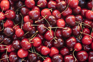 Background image of lying red ripe sweet cherries. Top view. Flat lay. Copy space