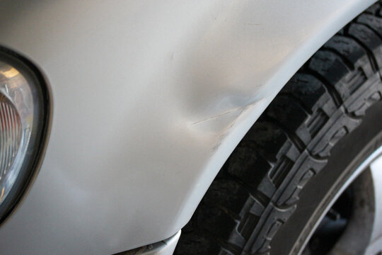 Panel damage on a silver SUV